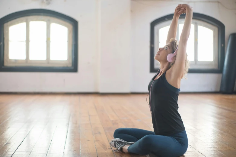 a woman doing stretching exercises on the floor