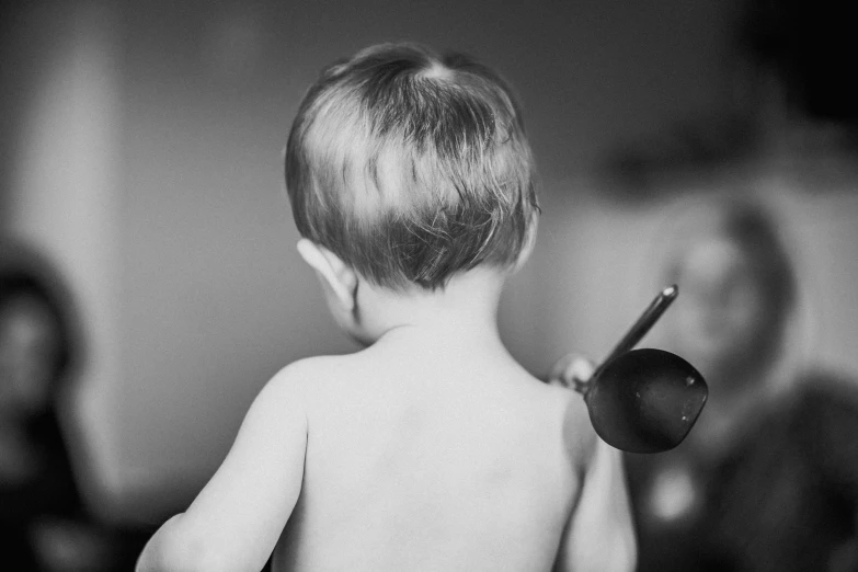 a black and white po of a child brushing its hair