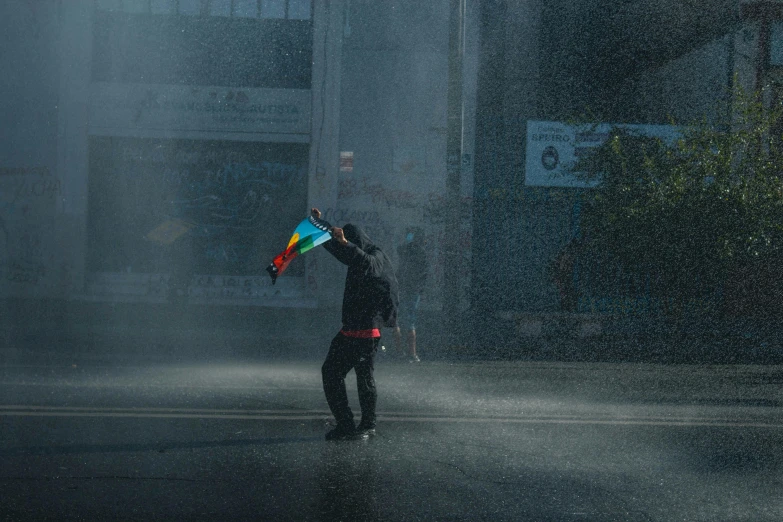 a person holding a kite on a rainy day