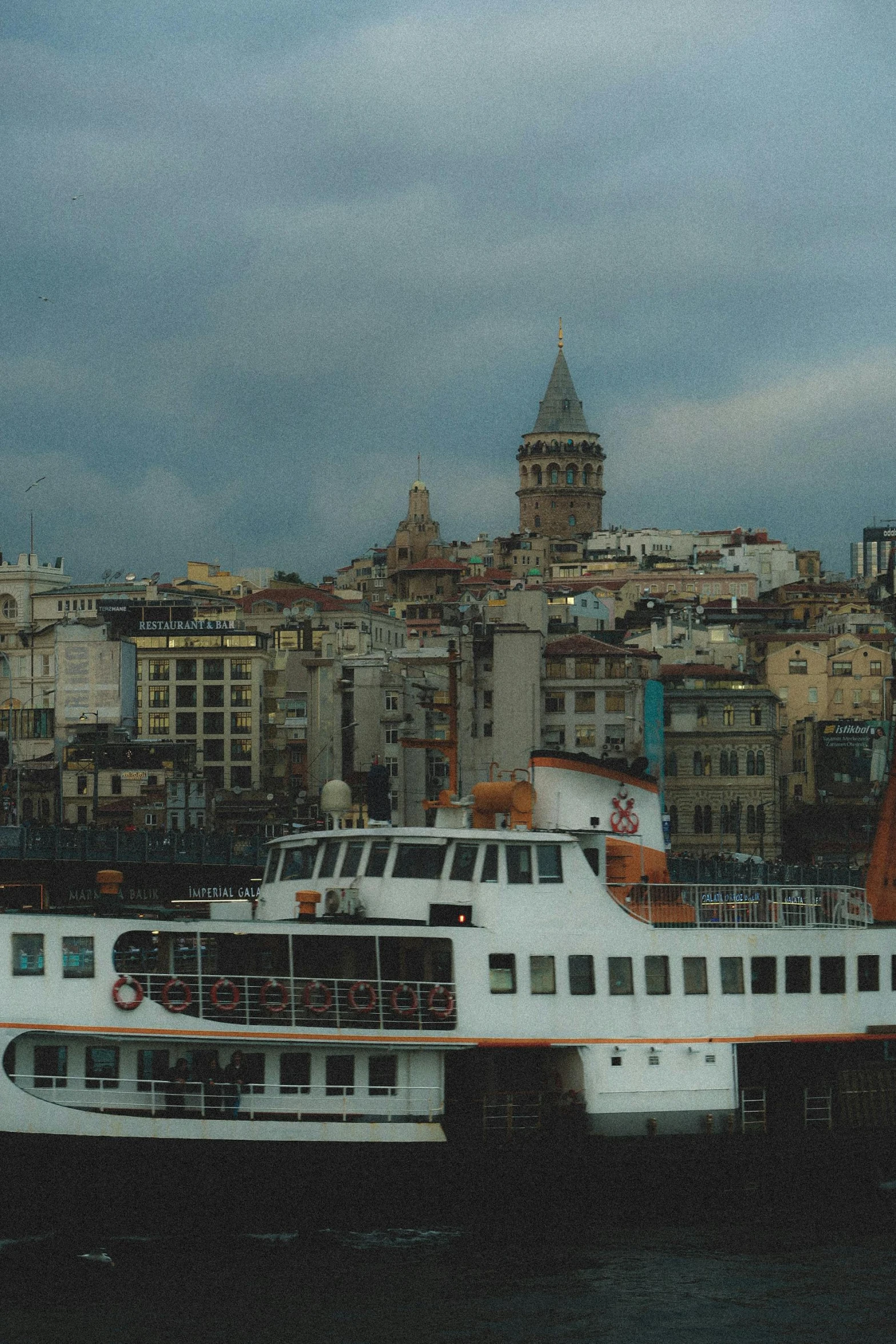 the ferryboat is pulled over to shore as dusk approaches