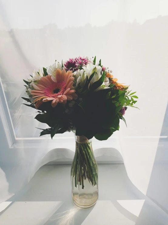 a glass vase full of flowers on top of a table