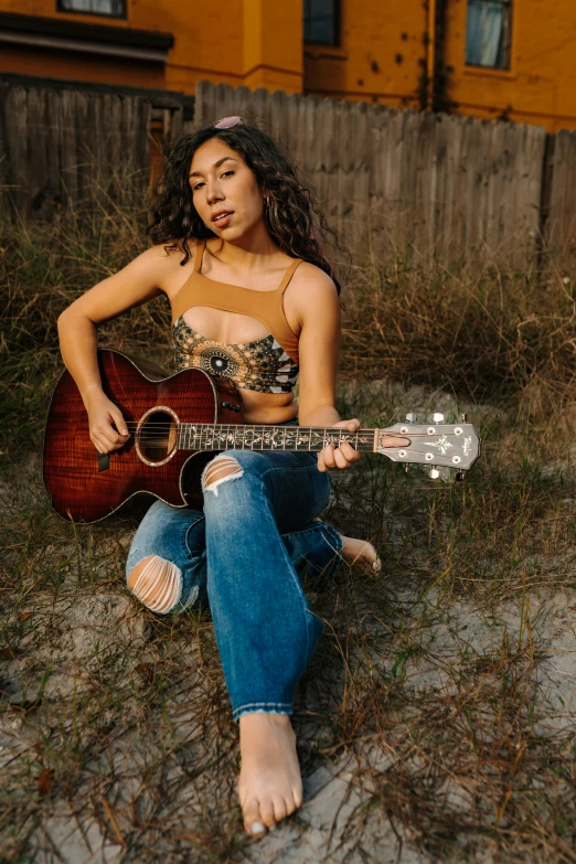 a girl is holding a guitar and smiling