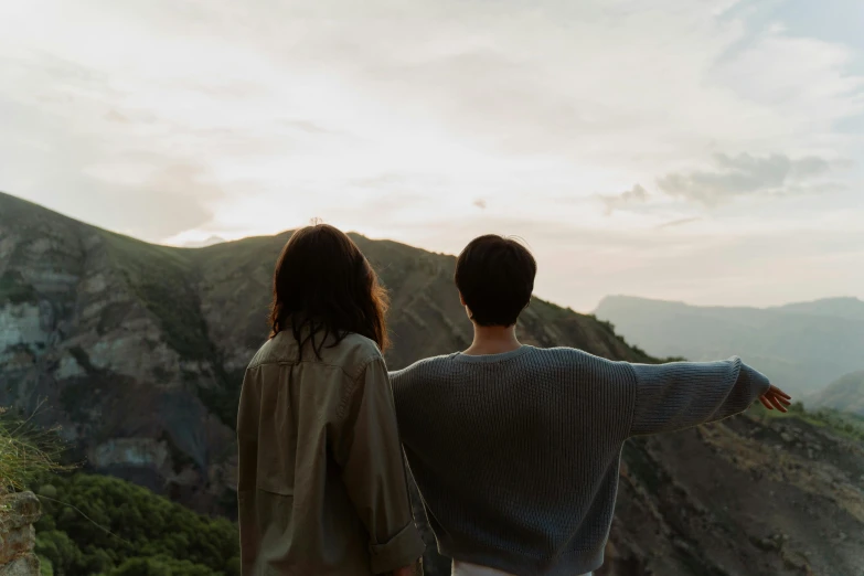 couple admiring the scenery from a hilltop while standing together