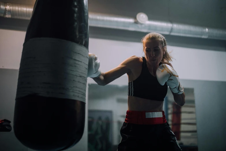 a woman is boxing on an exercise ring