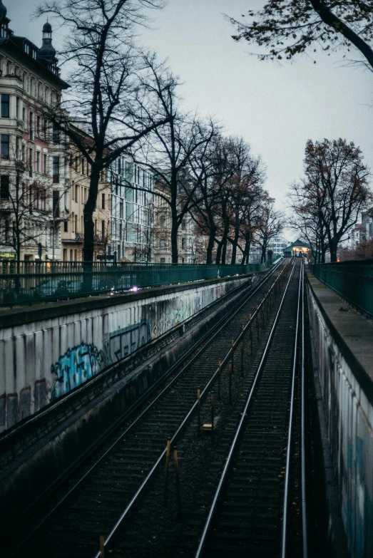 the tracks running alongside the buildings have been covered in graffiti