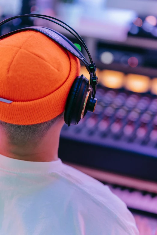 a man wearing a beanie with headphones around his ears