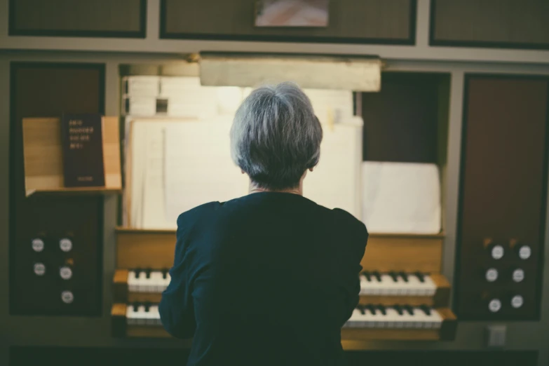 person standing near many musical equipment in a recording studio