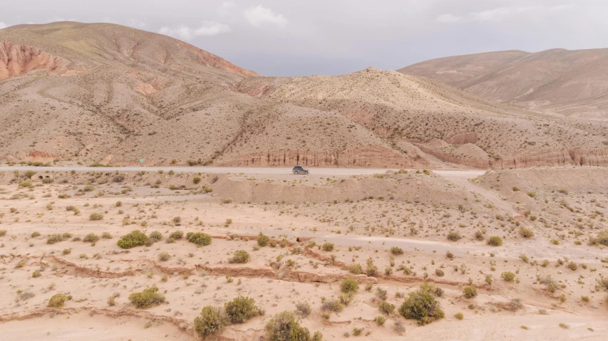 a car is traveling down the dirt road