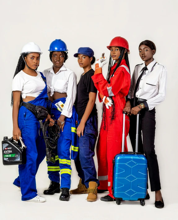 four woman dressed in construction costumes, one holding a phone