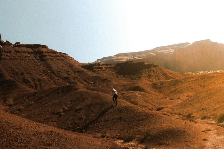 a man climbing down a mountain near mountains