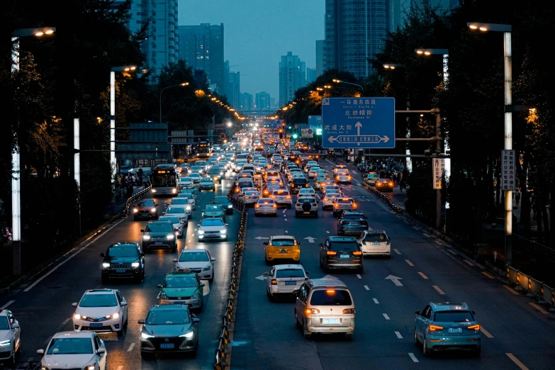 a view of a city at night, from a distance, where many cars are on the road