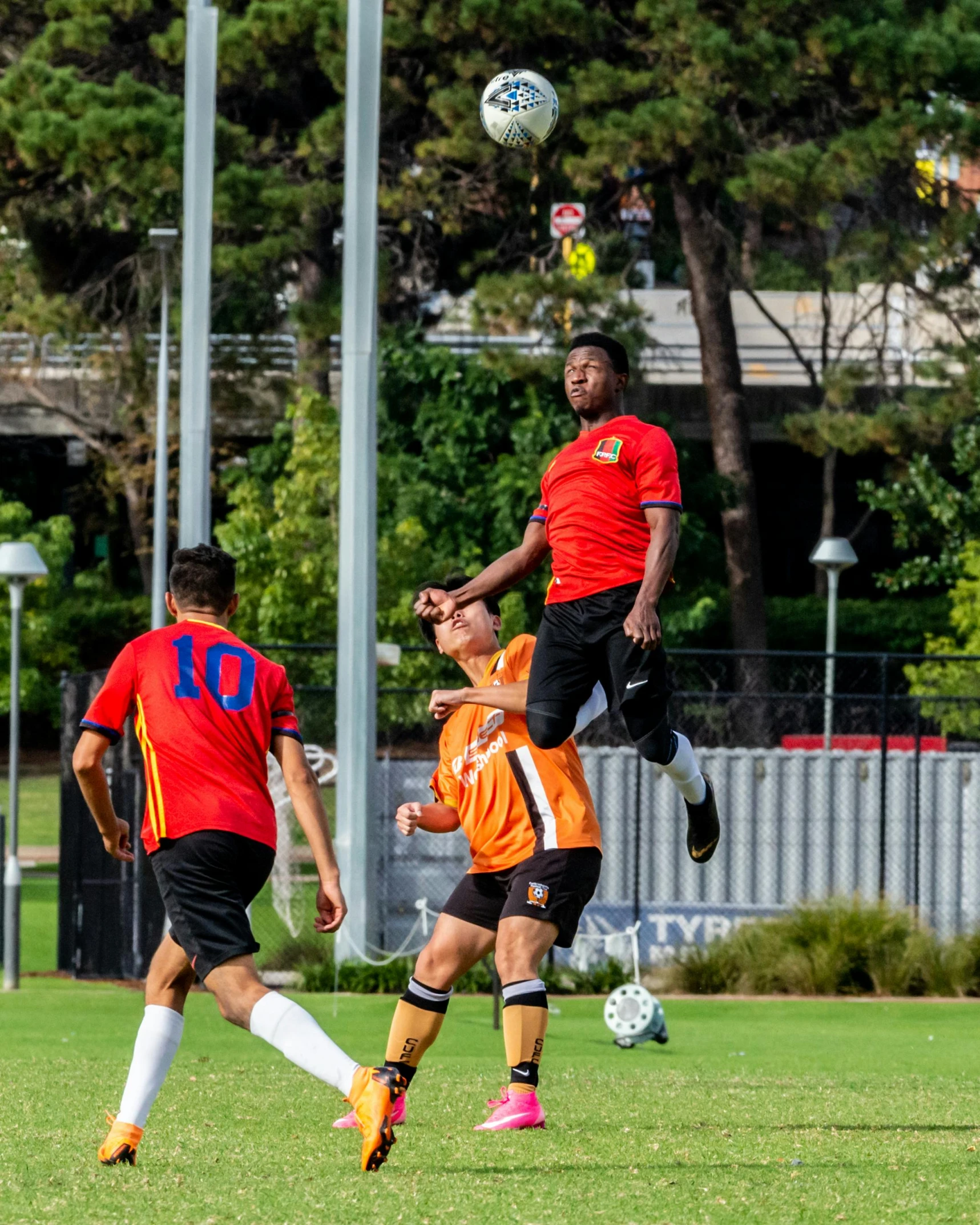 two soccer players are doing tricks for the ball