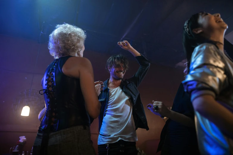 two women are dancing with one another at a concert