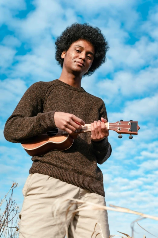 a man holding an ukulele in his hands