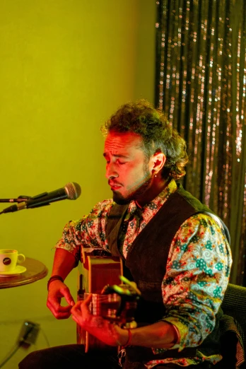 a man plays a musical instrument at a microphone