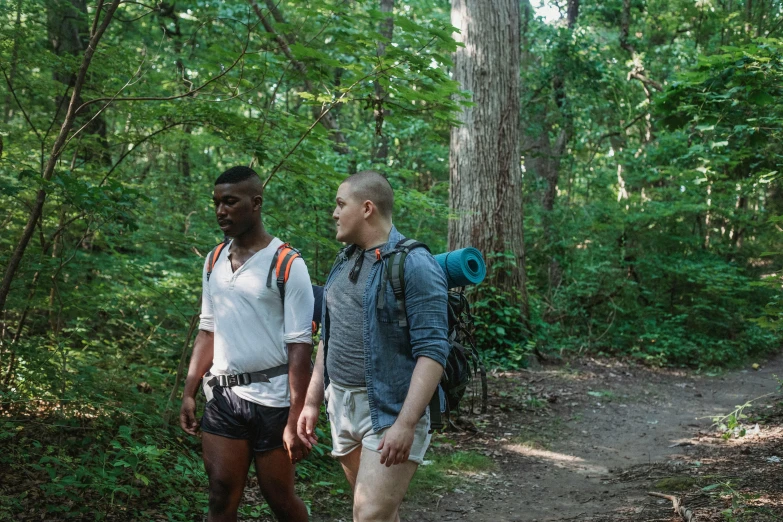 two people on a trail in the woods