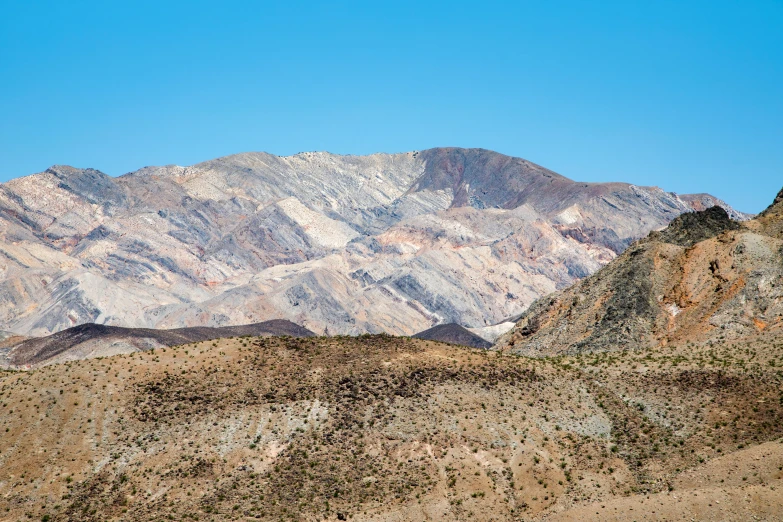 the mountain tops are snow covered with patches