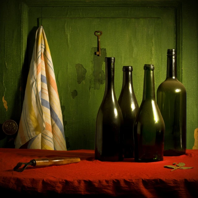 a bunch of bottles sitting on a red cloth