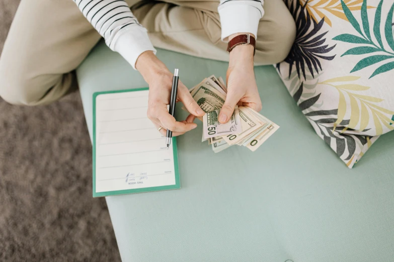 a person in white shirt with notebook on table