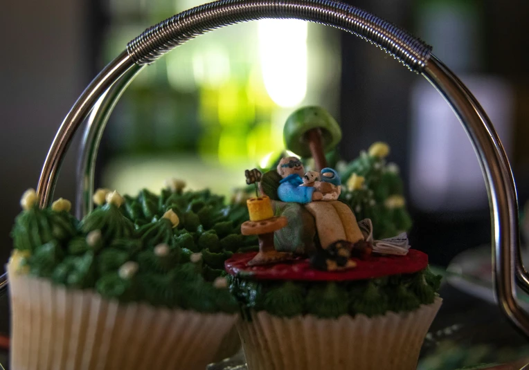 a cupcake with a small figurine of an older couple on top