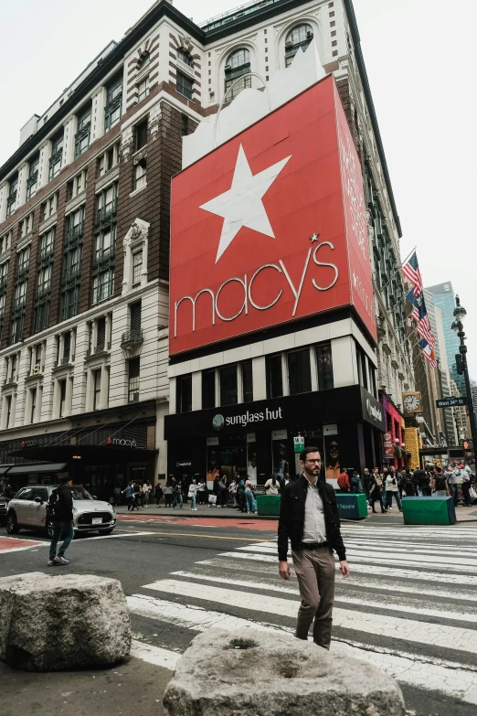 the man stands in front of the macy's store