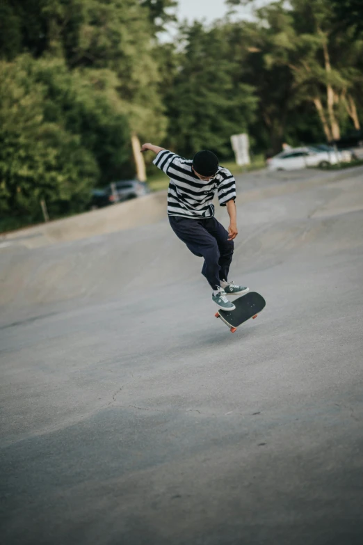 a young person riding a skateboard up the side of a ramp