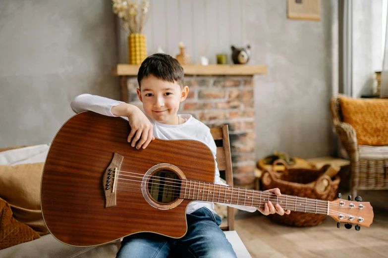 there is a  sitting with a guitar in his lap