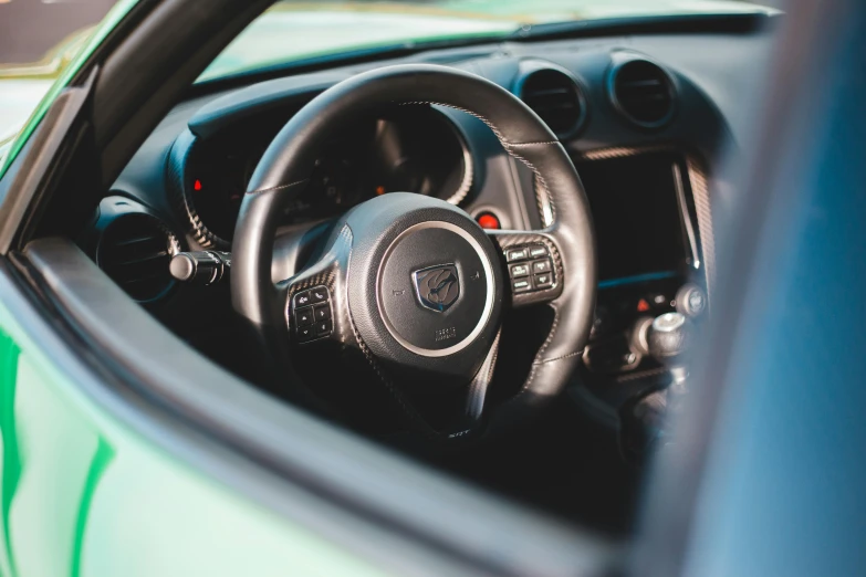 the dashboard and steering wheel of a sports car