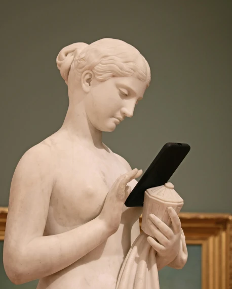 a statue has a tablet in his hands