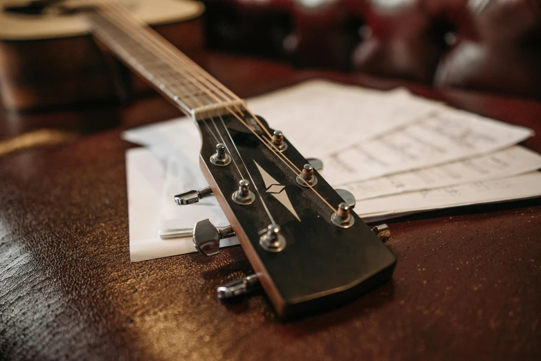 an old guitar is laying on the table