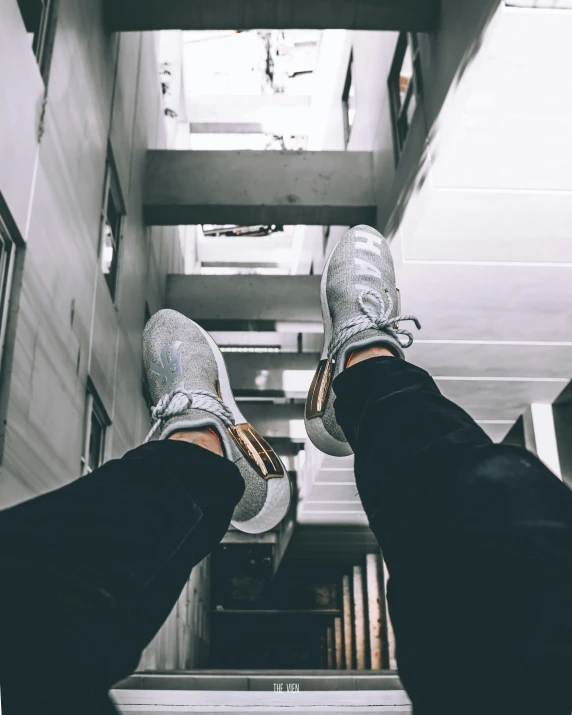 someone standing at the top of a steeple with their feet up