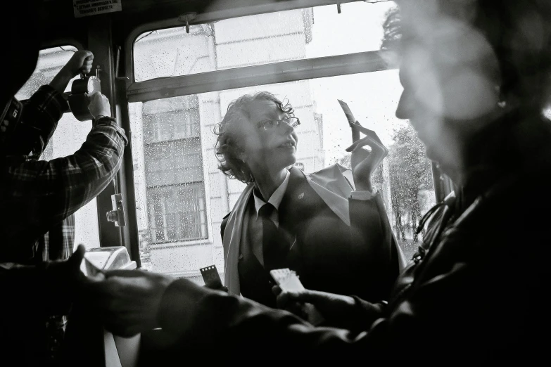 three men are standing in front of a window