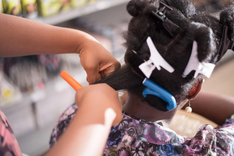 a girl with scissors is using scissors to cut a piece of fabric