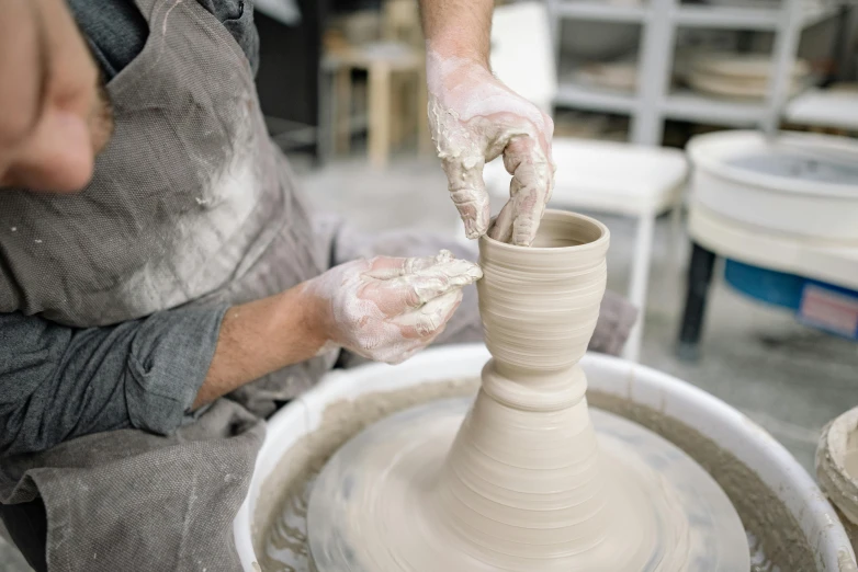 a person doing soing with some sort of pottery