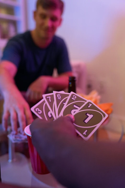 someone holding up some playing cards in their hand