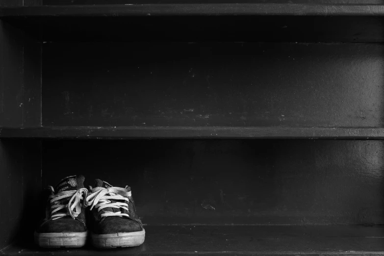 a black and white po of some shoes on the shelves