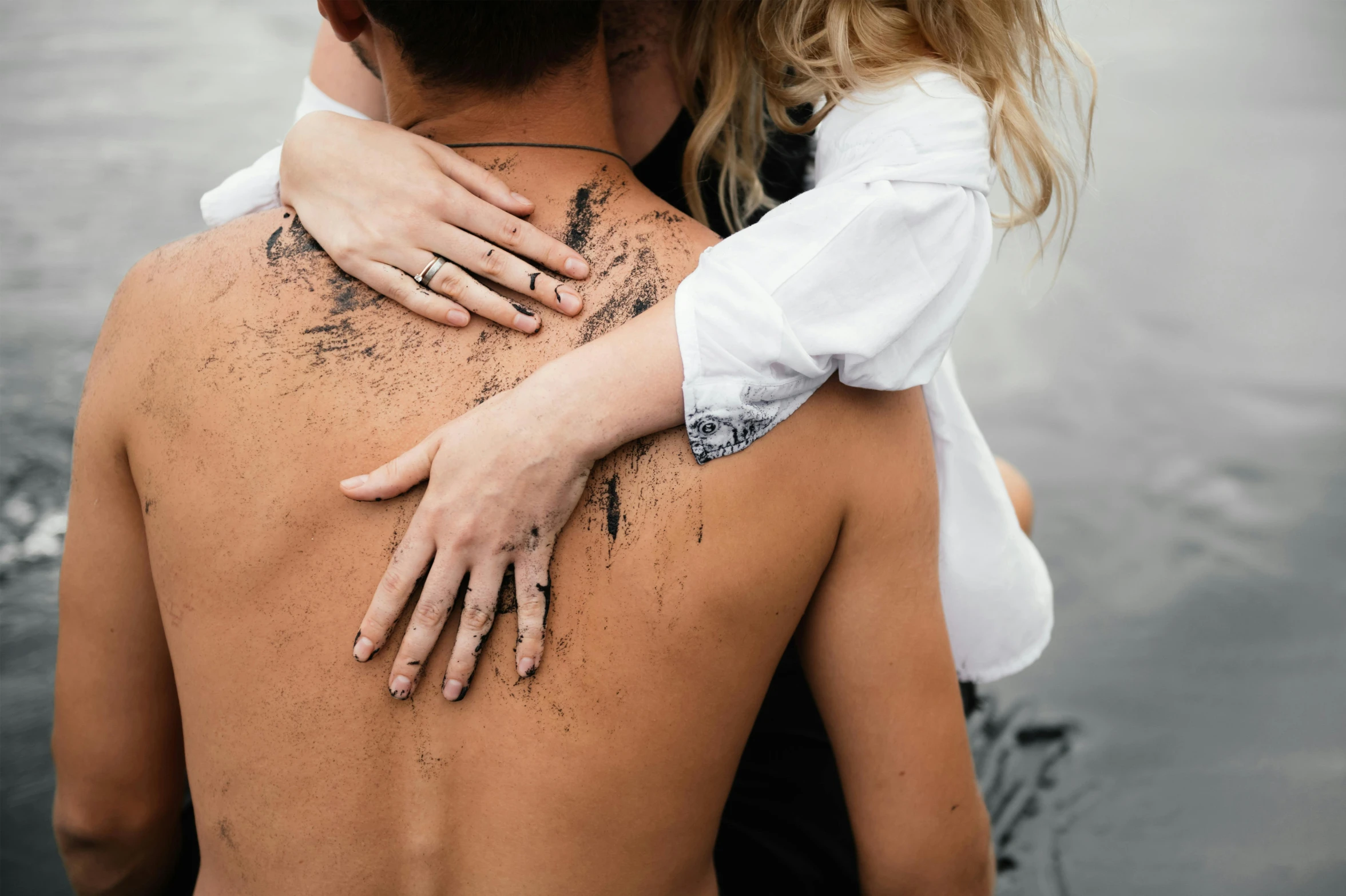 man kissing a woman while they are in the water