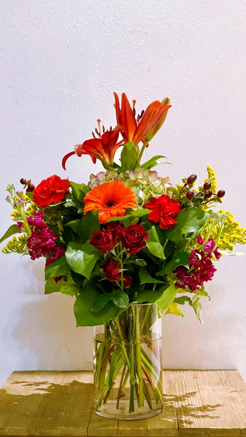 a vase with many colorful flowers on top