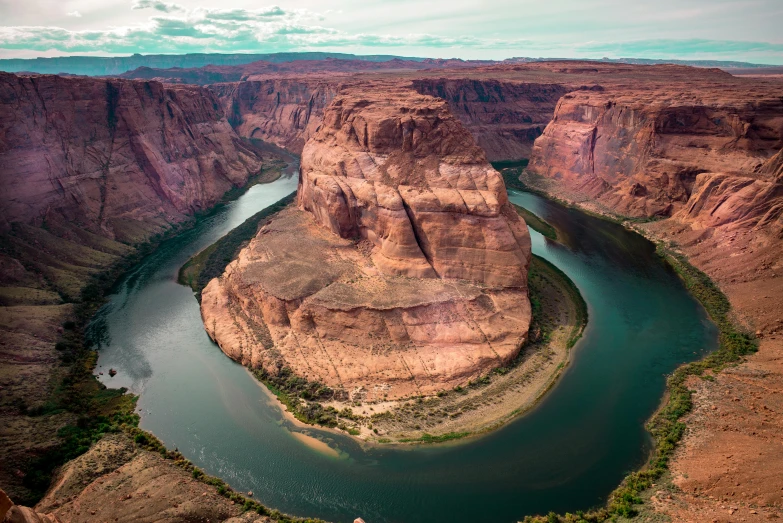 a canyon is shown with some green water in the middle of it