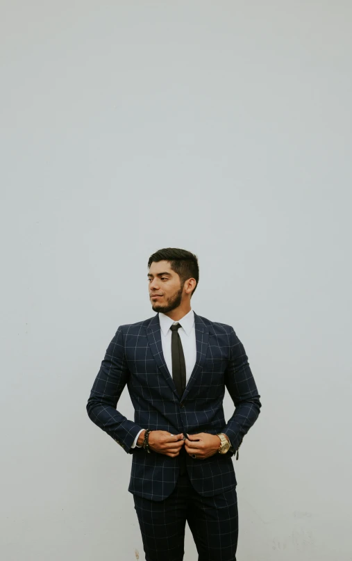 a man in a suit and tie looking away from the camera