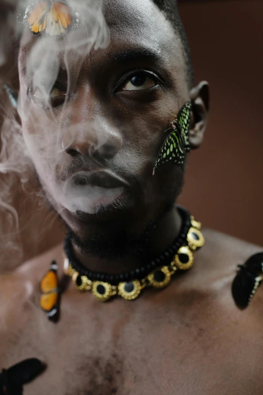 a person with smoke and erfly on their head
