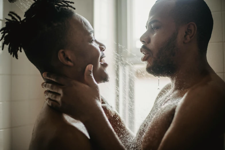 a shirtless man and his companion stand side by side as they wash their teeth
