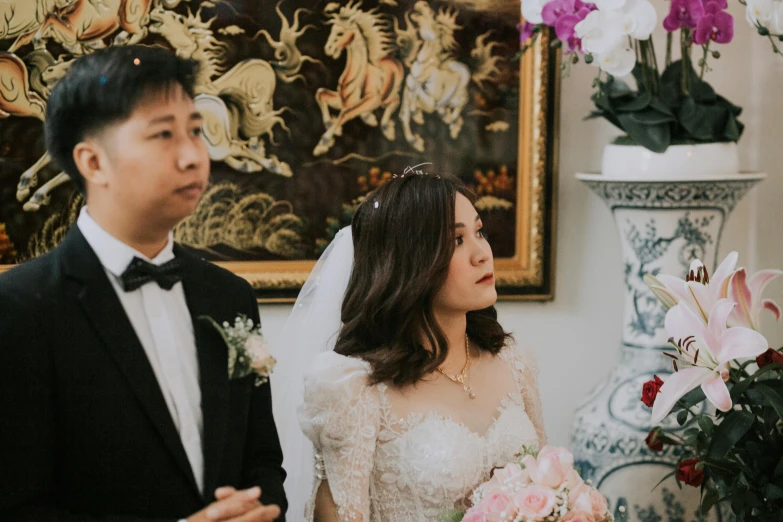 a married couple hold hands while the bride smiles