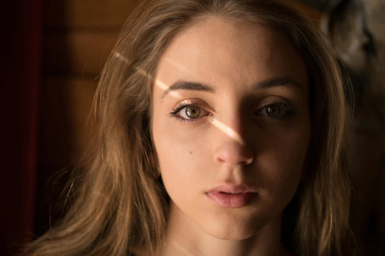 a young woman looks directly into the camera lens