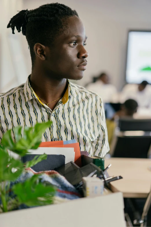 a person in a striped shirt at a desk