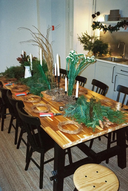 a dining room table that has several place settings for centerpieces