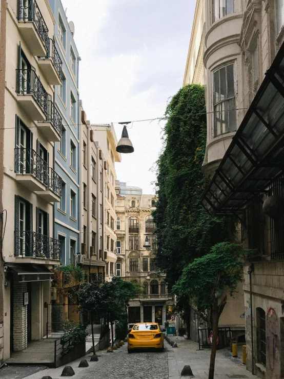 a street with cars parked and people walking on it