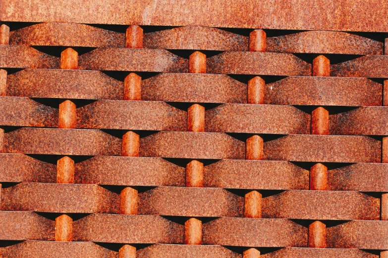 a red brick wall has two pointed brown bricks