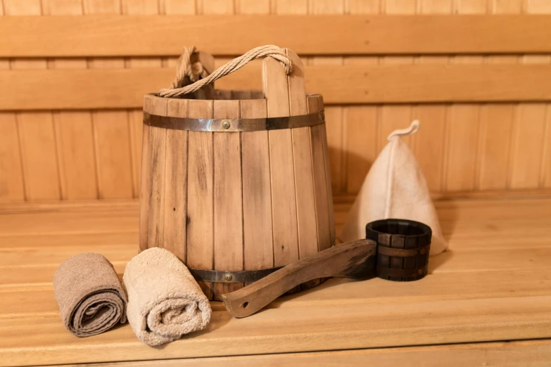 a bathrobe and two towels sitting on a wooden shelf