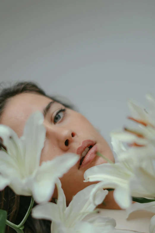 a close up of a person laying down with white flowers